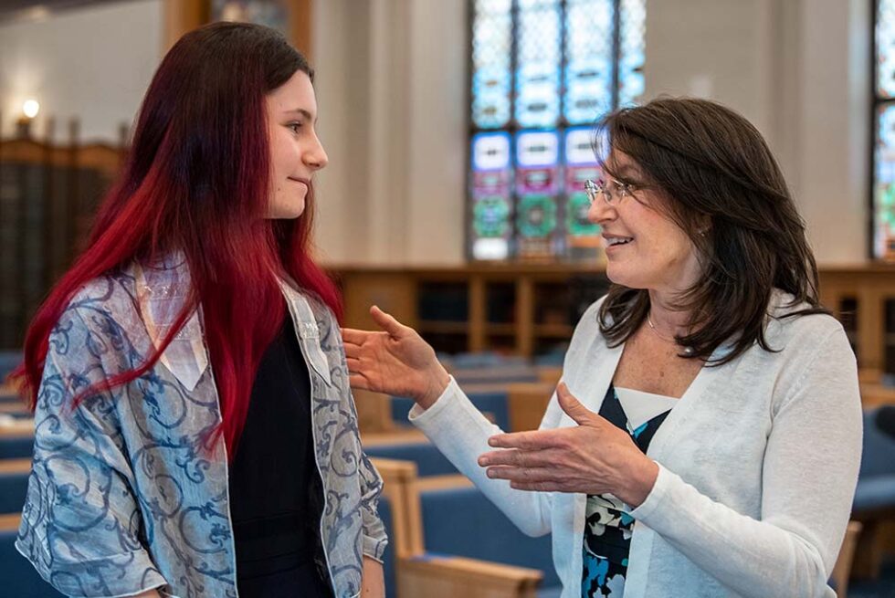 girl at her bat mitzvah with a rabbi