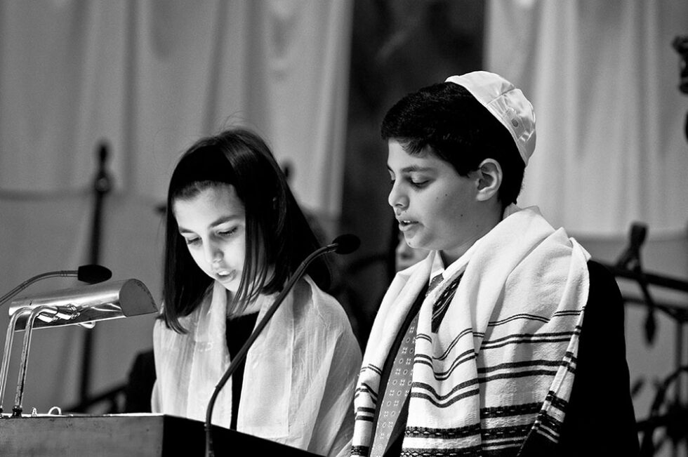 boy reading a torah scroll