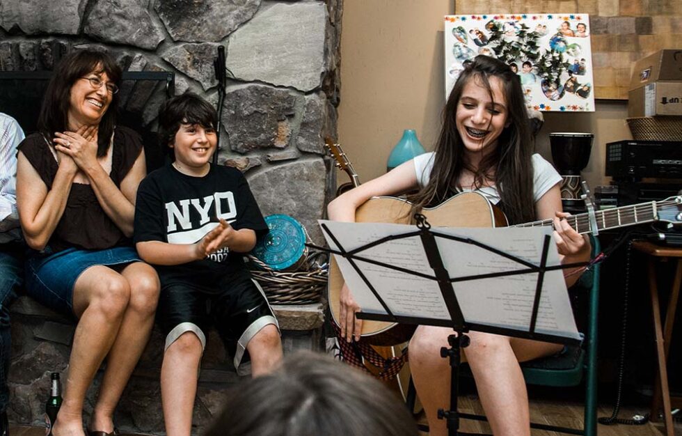 girl playing guitar at bat mitzvah