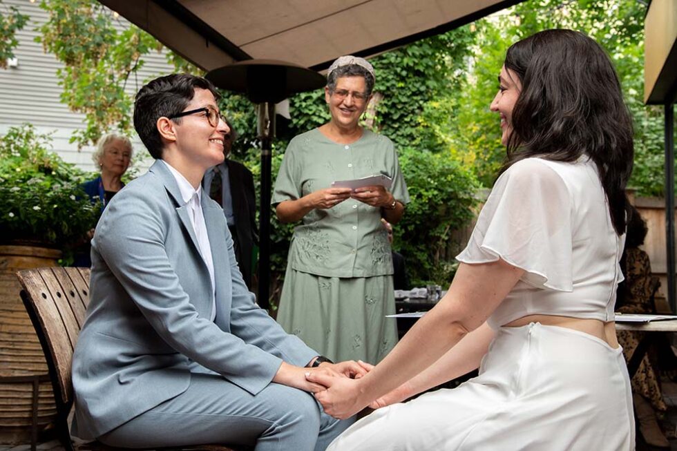 two women saying their vows for a rabbi
