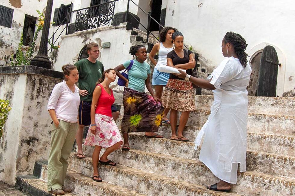 NYU students listening to professor while on trip abroad