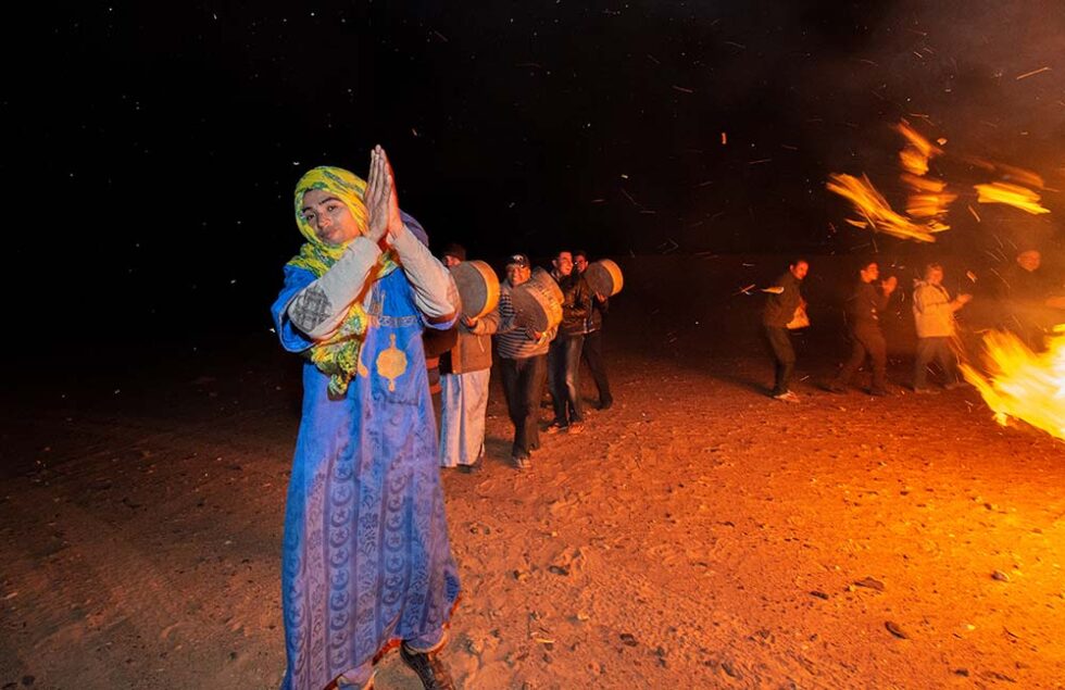 young man at a desert campfire