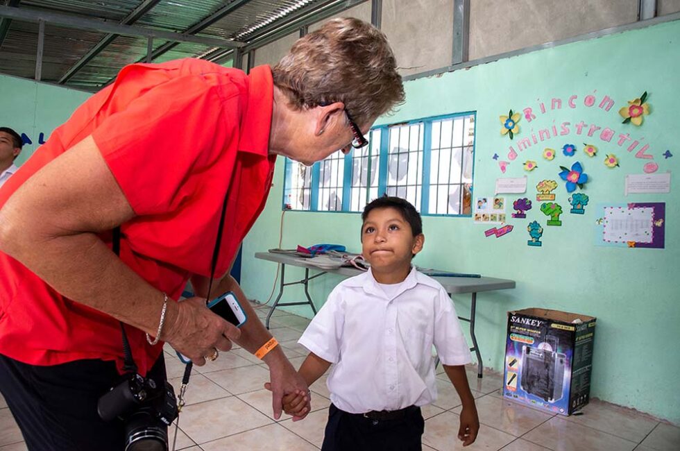 young boy and woman at a school in South America