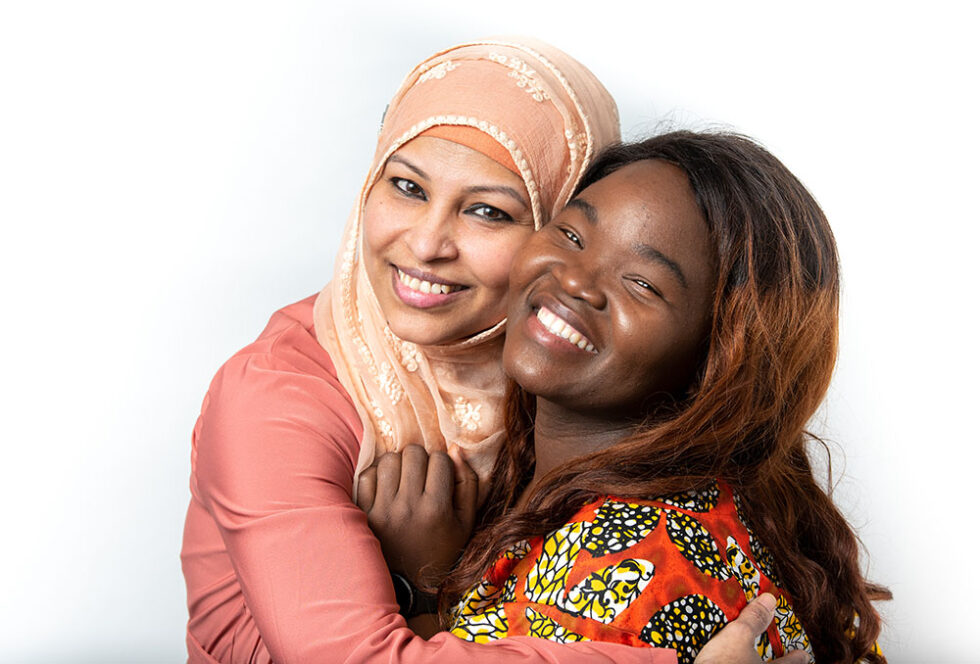 two women hugging and smiling
