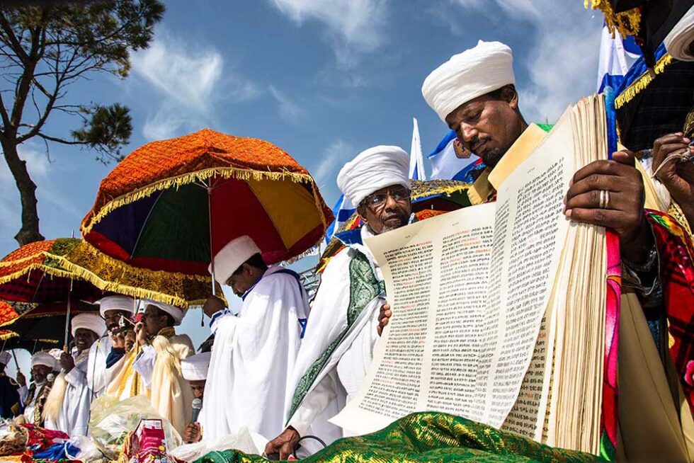 man holding a torah scroll in ethopia